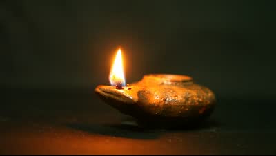 stock-footage-olive-oil-clay-ancient-lantern-lamp-flame-in-motion